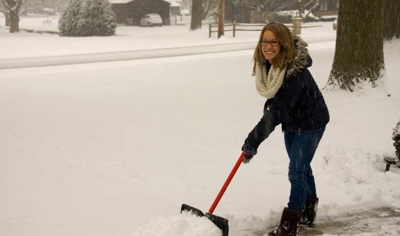 woman scraping snow